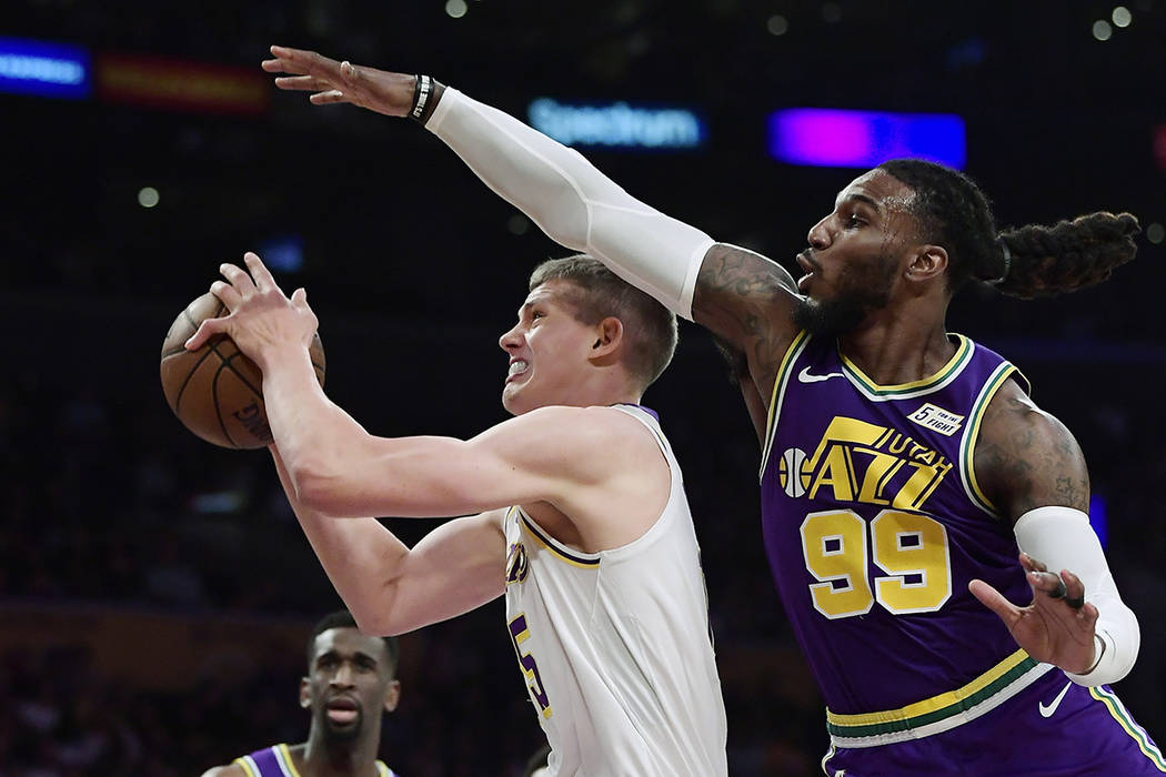 Los Angeles Lakers center Moritz Wagner, left, tries to shoot as Utah Jazz forward Jae Crowder ...