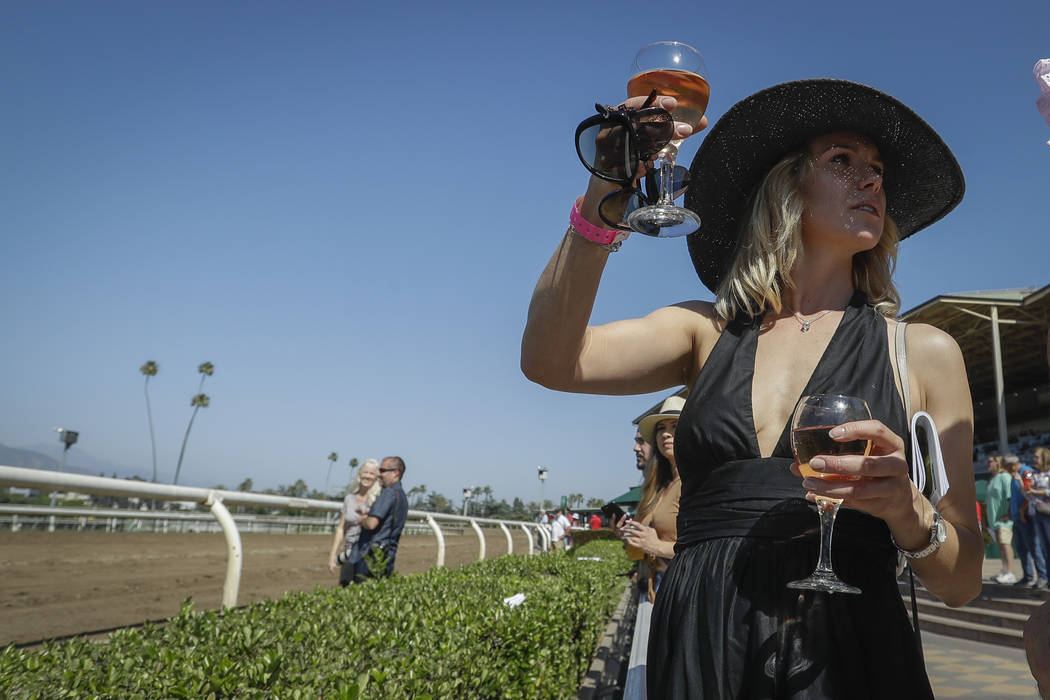 Olga Wardlaw waits for the sixth race during the last day of the winter/spring meet at the Sant ...