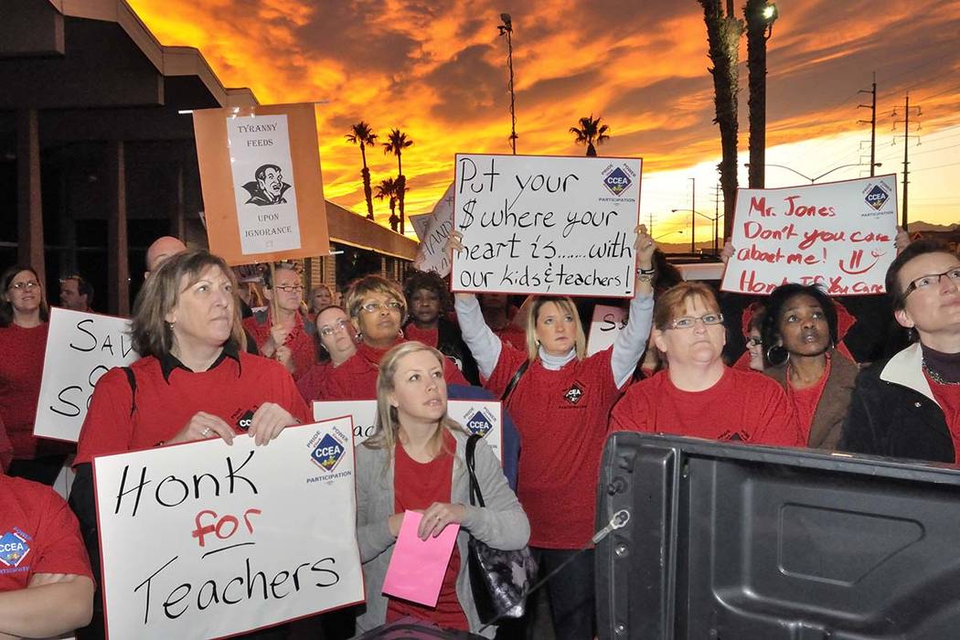 Clark County Education Association supporters listen to CCEA union president Ruben Murillo duri ...