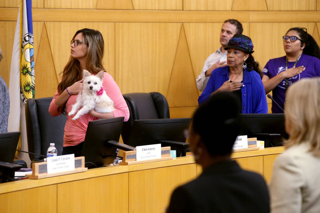 Trustees Danielle Ford, left, and Dr. Linda E. Young recite the Pledge of Allegiance during a C ...