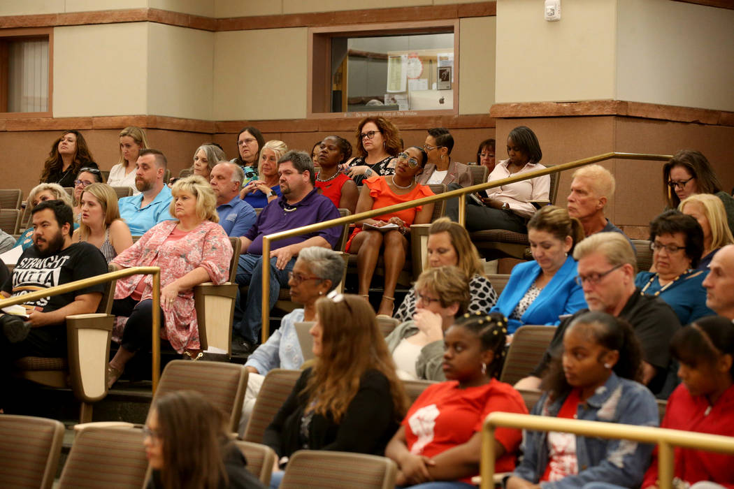 Audience members listen during a Clark County School Board meeting at the Clark County Governme ...