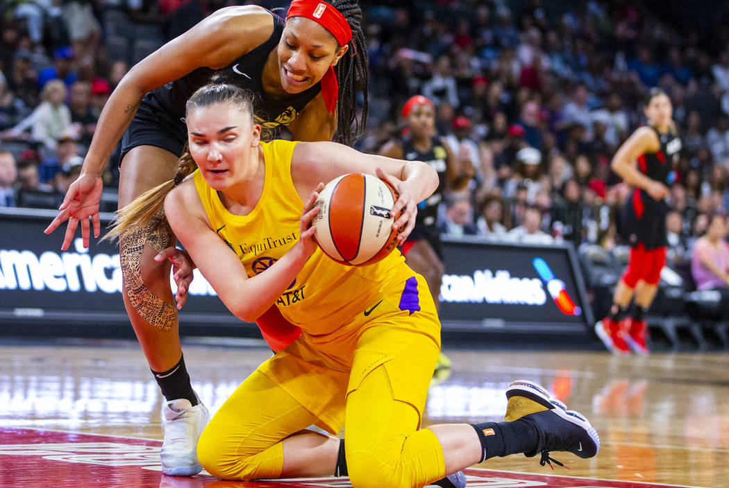 Las Vegas Aces center A'ja Wilson (22) looks down to the ball scooped up by Los Angeles Sparks ...