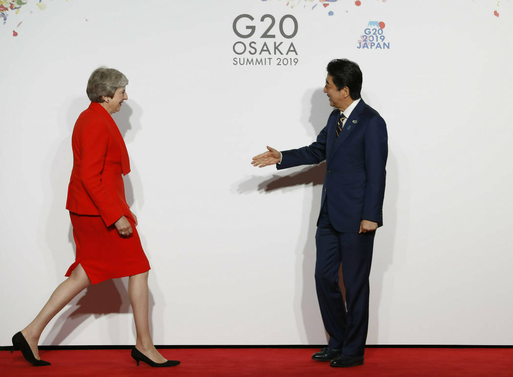 British Prime Minister Theresa May, left, is welcomed by Japanese Prime Minister Shinzo Abe upo ...