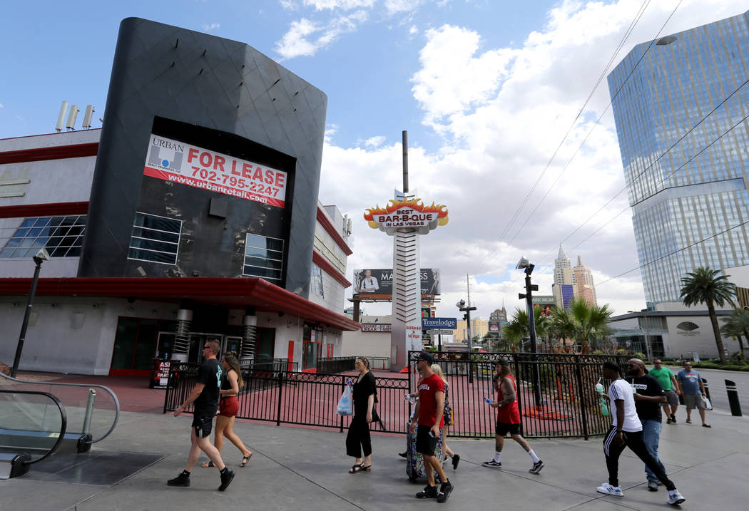 People walk on the Strip near Harmon Avenue past a 16-acre piece of property that includes the ...