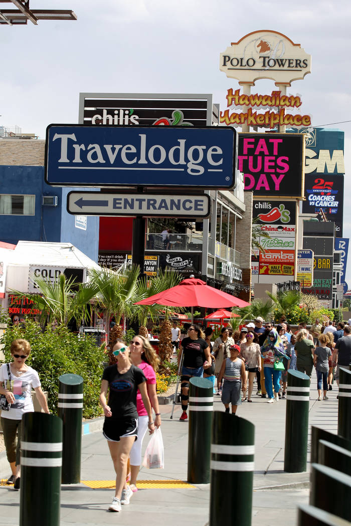 People walk on the Strip near Harmon Avenue past a 16-acre piece of property that includes the ...