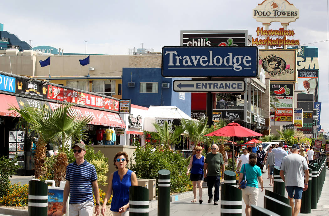 People walk on the Strip near Harmon Avenue past a 16-acre piece of property that includes the ...