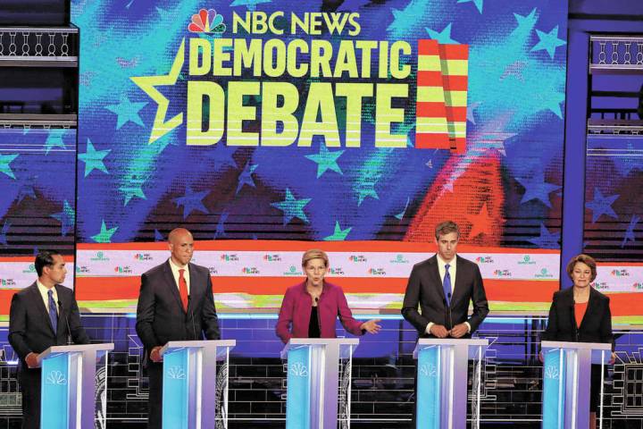 Democratic presidential candidate Sen. Elizabeth Warren, D-Mass., center, answers a question, d ...