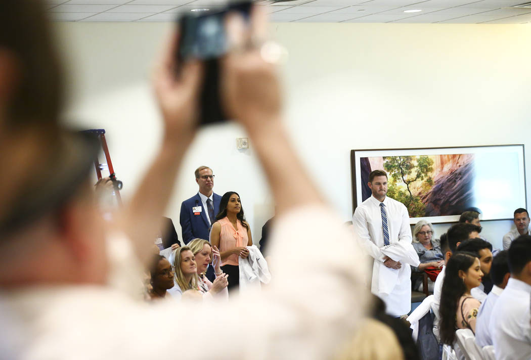 Family medicine resident Swetha Vakkalanka, center left, participates in a white coat ceremony ...