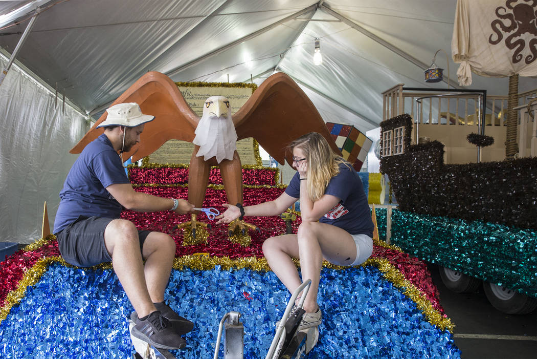 Julien Mihy, left, and Jordyn Doyle put the finishing touches on a float titled "Salute to ...