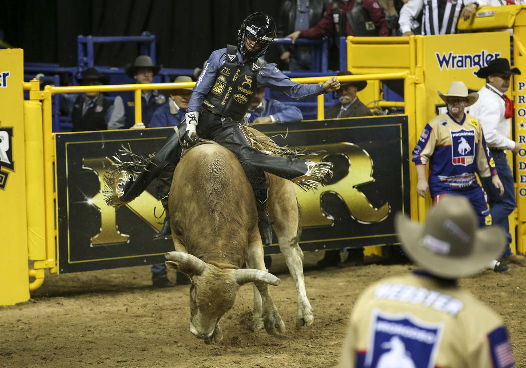 Sage Kimzey of Oklahoma takes part in the bull riding competition during the third go-round of ...