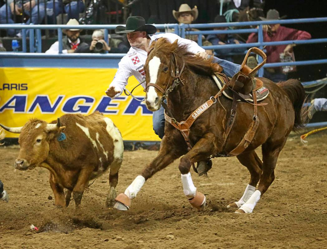 Ty Erickson of Helena, Mont. (59) competes in the steer wrestling event during the ninth go-rou ...