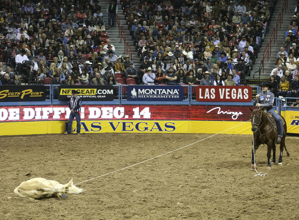 Sterling Smith of Stephenville, Texas (89) competes in the tie-down roping event during the nin ...