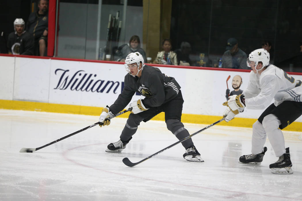 Vegan Golden Knights' Mitchell Chaffee, left, looks to make a play under pressure from Ryder Do ...