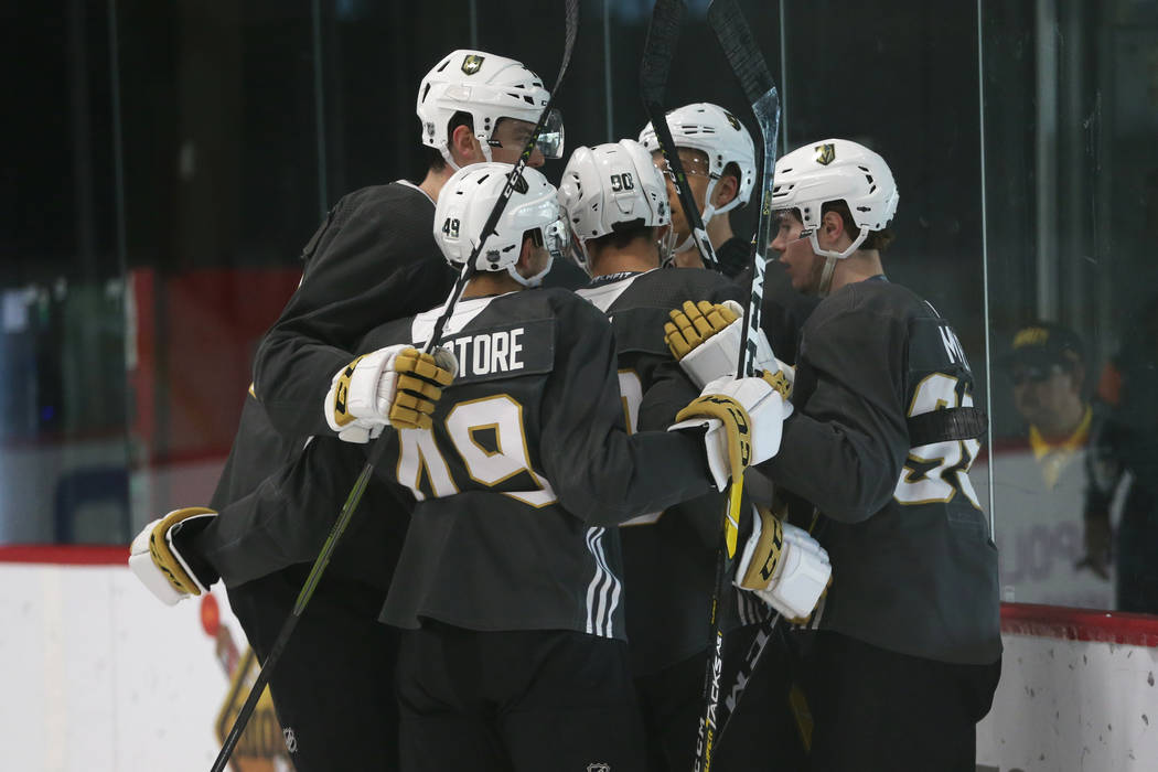 Players celebrate a goal by Vegas Golden Knights' Zak Smith during a development camp scrimmage ...