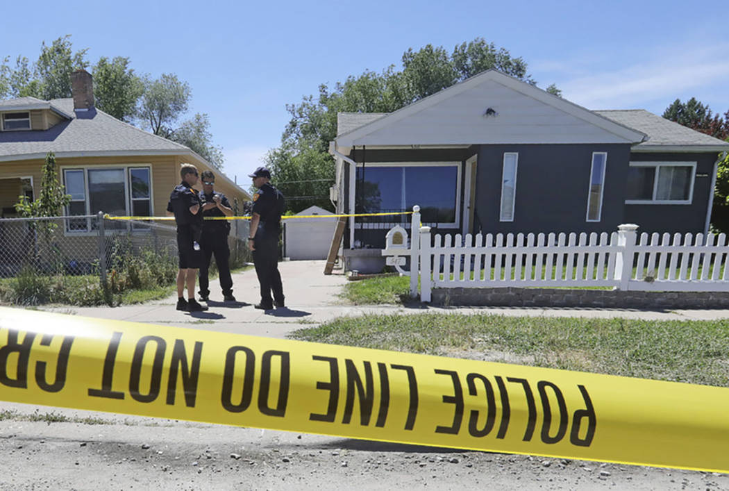 Police officers stand in front of the home, right, of Ayoola A. Ajayi Friday, June 28, 2019, in ...