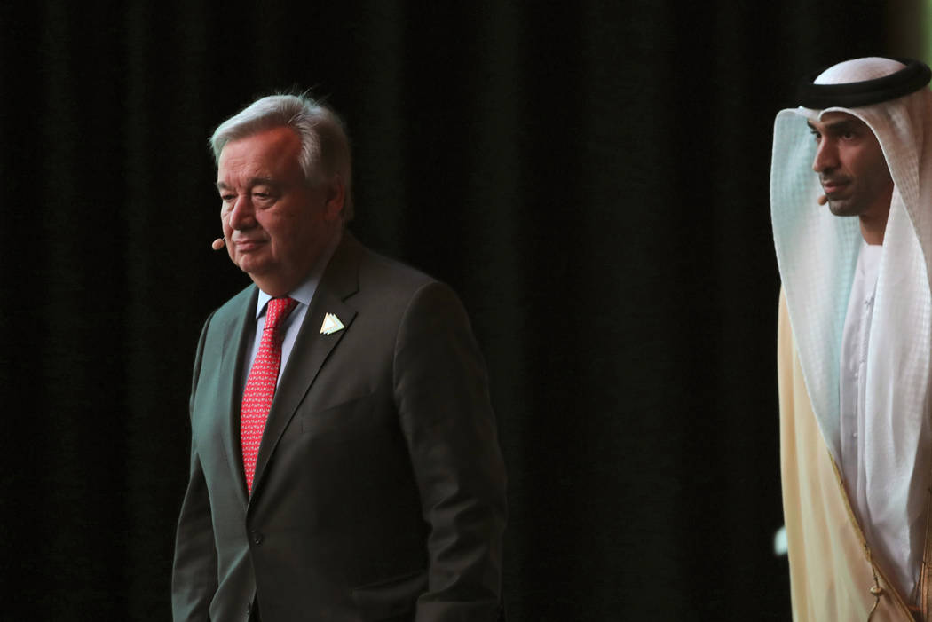 United Nations Secretary General Antonio Guterres, left, followed by Thani bin Ahmed Al Zeyoudi ...