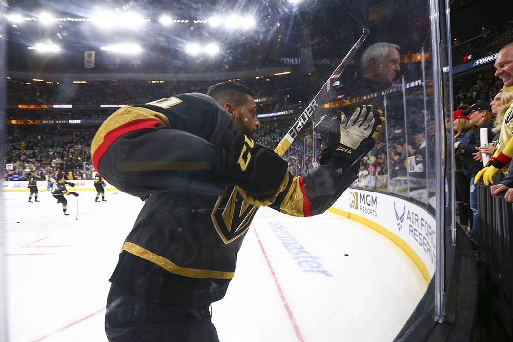 Golden Knights center Pierre-Edouard Bellemare (41) slams into the glass during warmups before ...