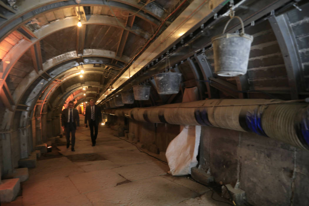 People walk inside an ancient tunnel during the opening of an ancient road at the City of David ...