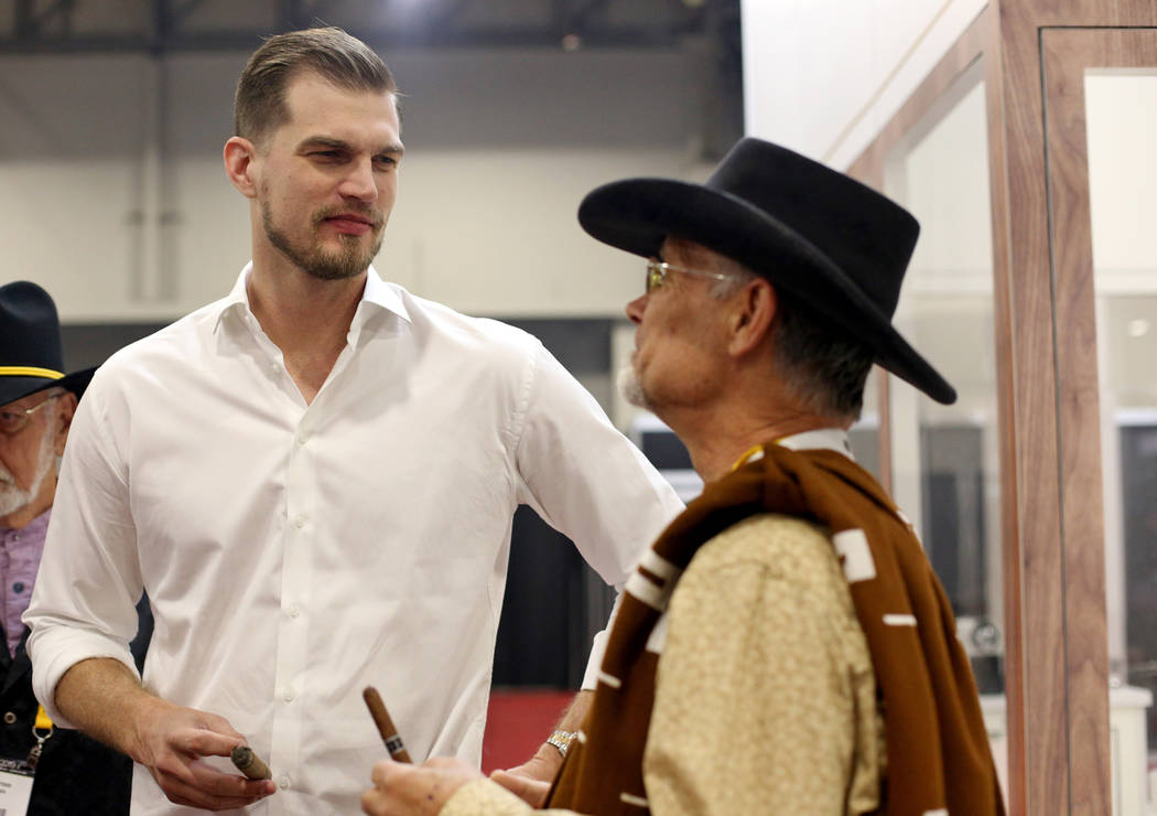 Tiago Splitter, former NBA player, speaks to Mike Bieket at the A.C.E Prime cigar booth at the ...