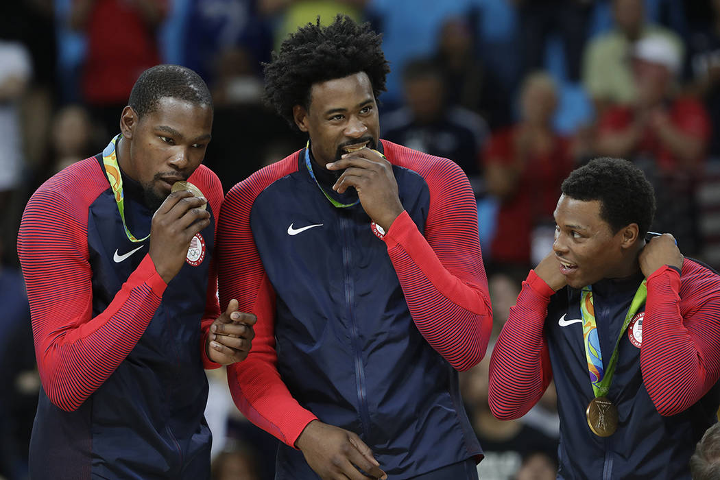 From left, United States' Kevin Durant, DeAndre Jordan and Kyle Lowry pose with their gold meda ...