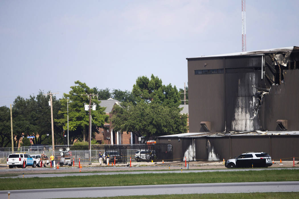 Damage is seen to a hangar after a twin-engine plane crashed into the building at Addison Airpo ...