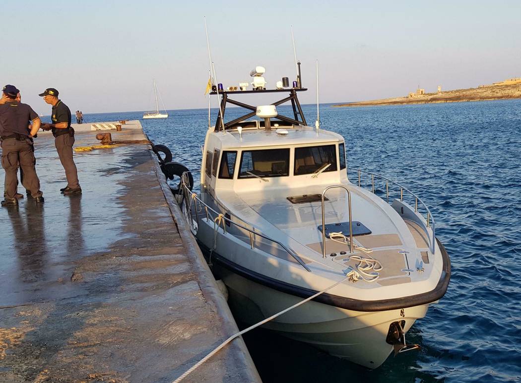 An Italian border police motorboat is moored at Lampedusa island's harbor, Italy, after being ...