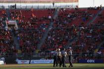 Referees meet at midfield during a tv timeout during the UNLV Nevada football game at Sam Boyd ...