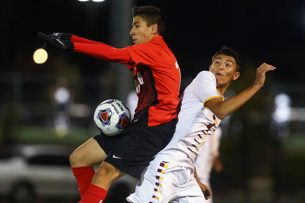 Coronado’s Diaz Alfredo (13) traps the ball while under pressure from Eldorado’s ...