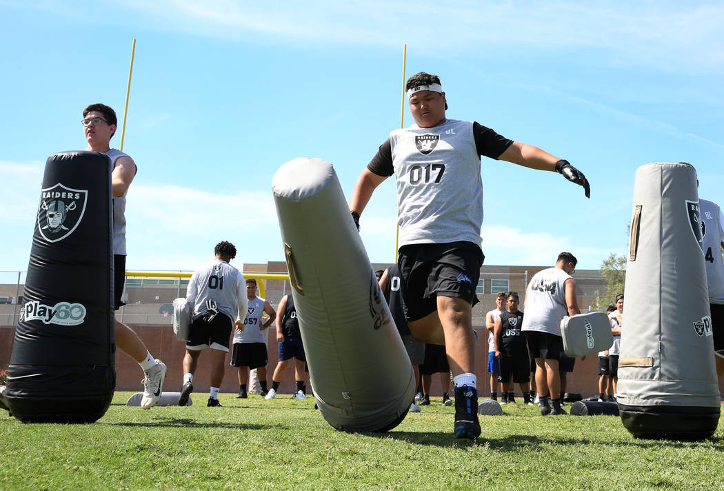 Henry Lim, right, Basic High’s offensive guard, hits a bag as local Clark County area ...