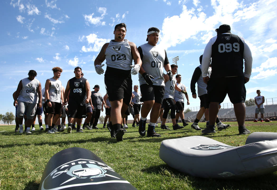 Former Faith Lutheran high school’s offensive line coach De’Andre Nicholas, righ ...