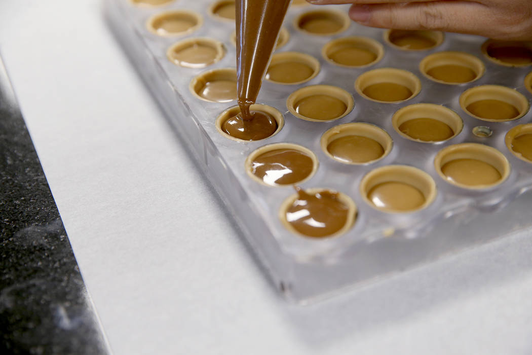 A student makes a chocolate creation at Melissa Coppel's Las Vegas chocolate school Thursday, M ...