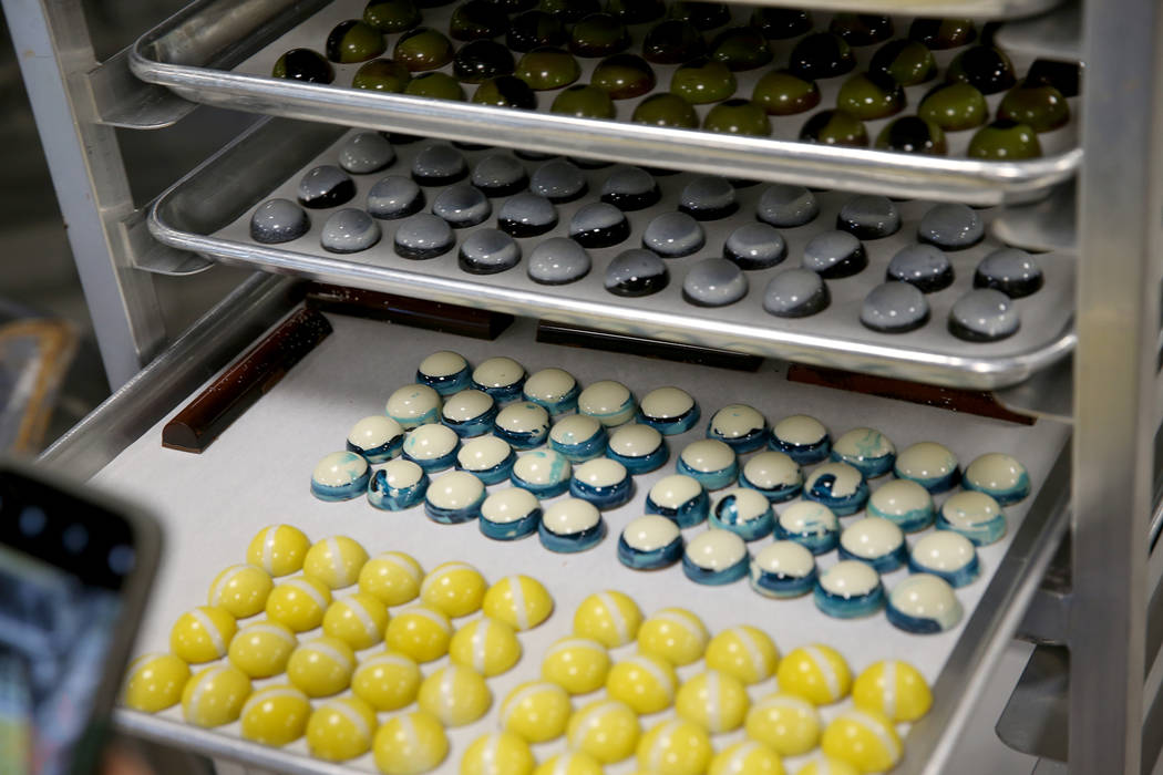 A student takes a photo of their chocolate creations at Melissa Coppel's Las Vegas chocolate sc ...