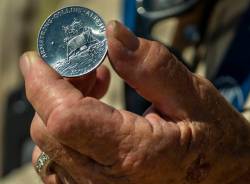 Ernie Williams with commemorative coin from the Apollo 11 mission within the Nevada National Se ...