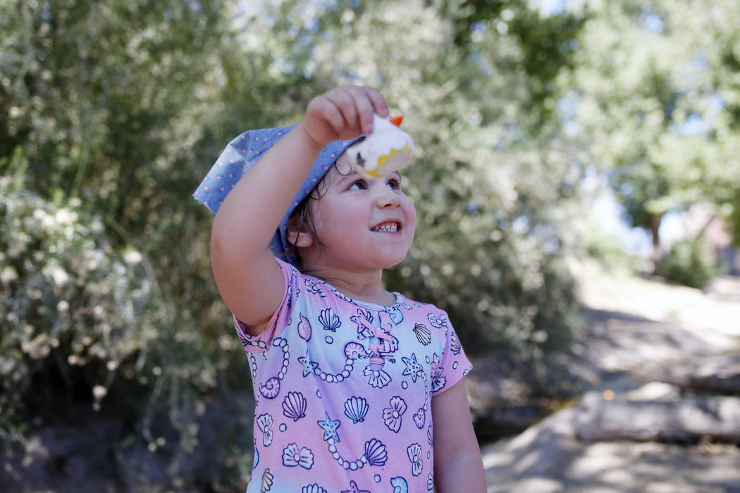 Addy Bartlett, 4, visiting family in Las Vegas, holds her plastic duck used in the duck race du ...