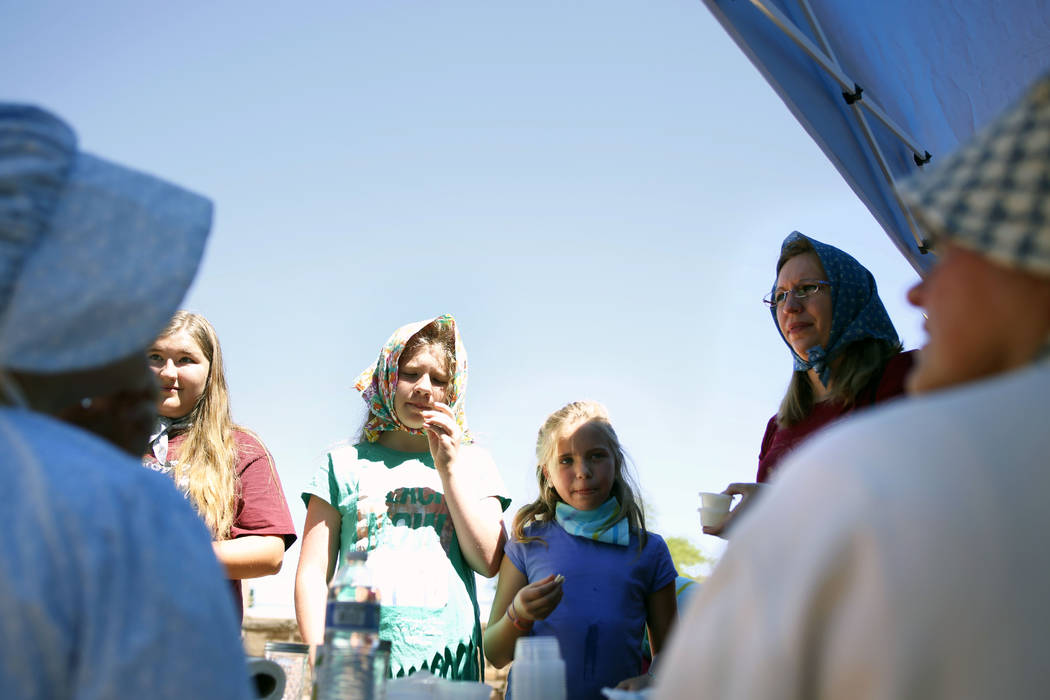 A family samples butter they made themselves during Pioneer Day at Old Mormon Fort in Las Vegas ...