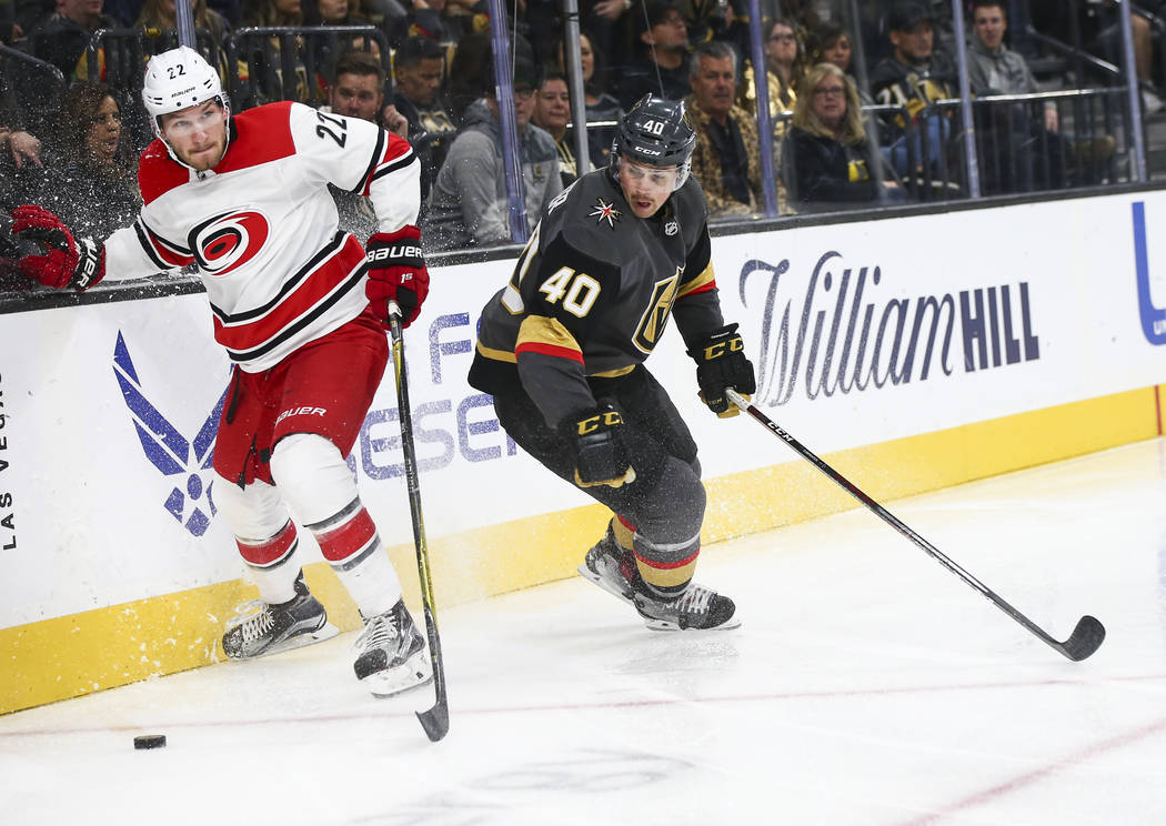 Carolina Hurricanes defenseman Brett Pesce (22) moves the puck past Golden Knights center Ryan ...