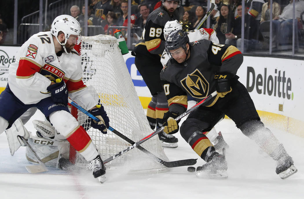 Florida Panthers defenseman Ian McCoshen (12) knocks the puck away from Vegas Golden Knights ce ...