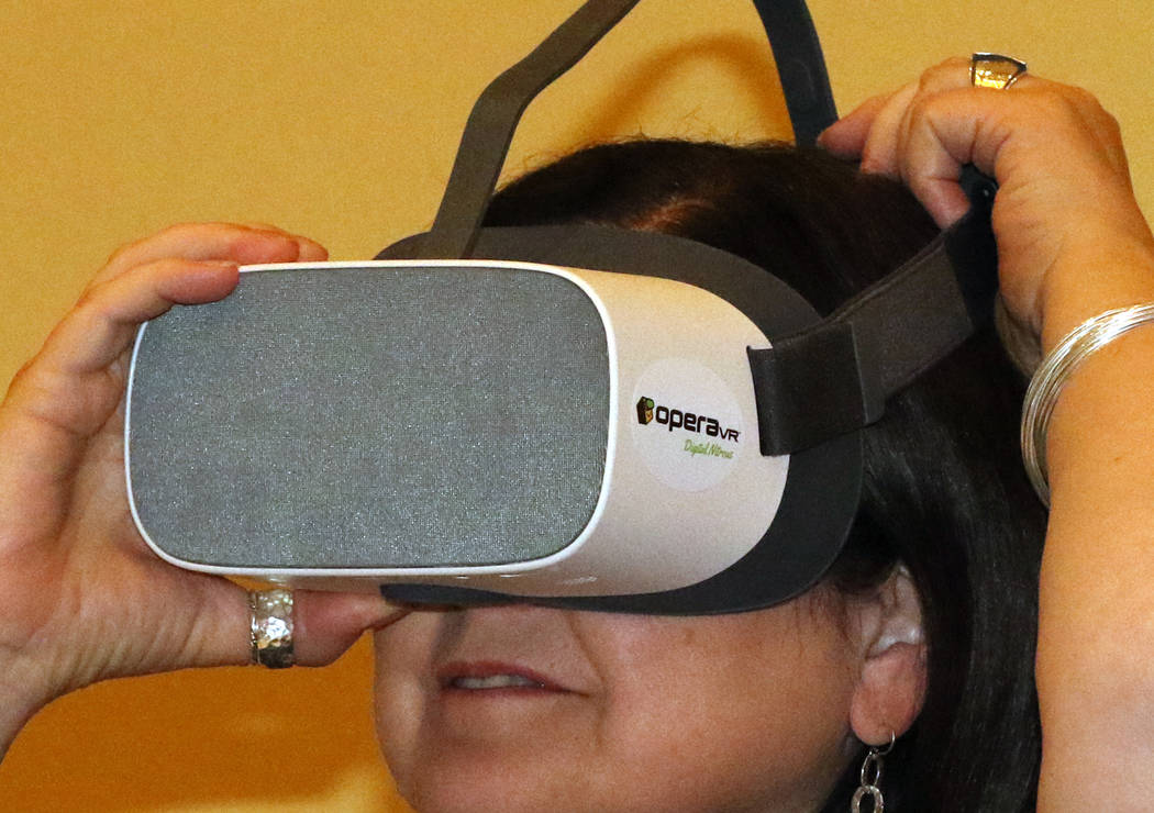 Diana Casey of Philadelphia checks out a virtual reality headset, which is used to alleviate pa ...