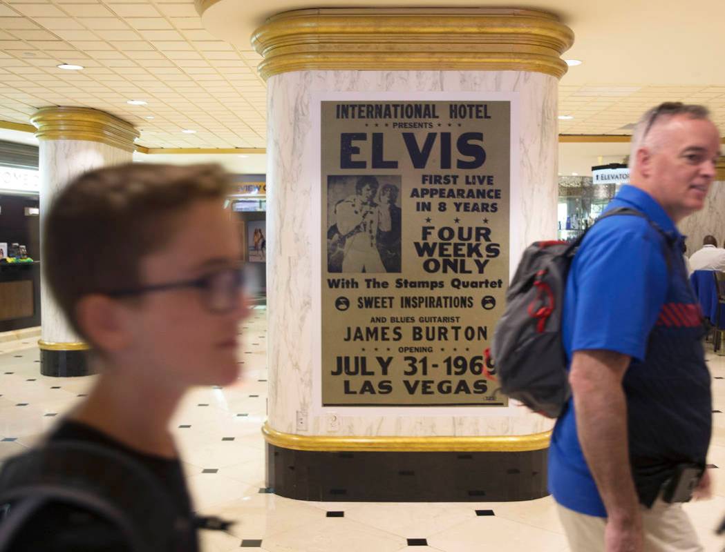 Guests pass a commemorative plaque celebrating Elvis Presley's shows at the International Hotel ...