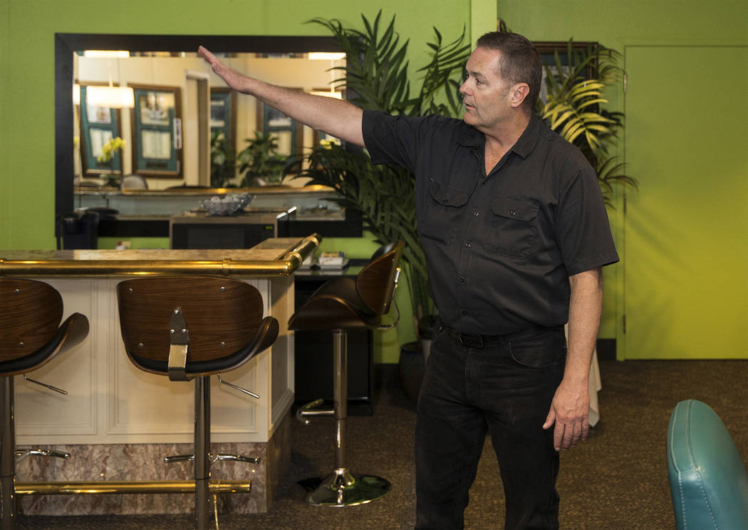 Craig Hayes, crew chief and head carpenter at the International Theater, points out features of ...