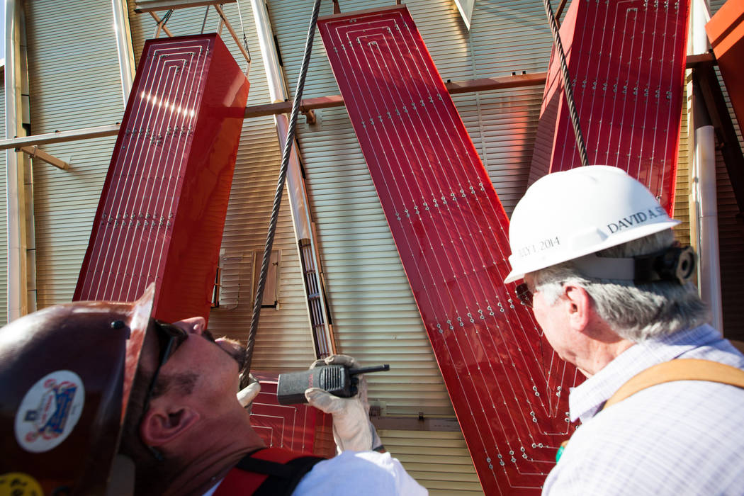 Westgate Resorts founder and CEO David Siegel, right, with Yesco sign installer Aaron Neal, are ...