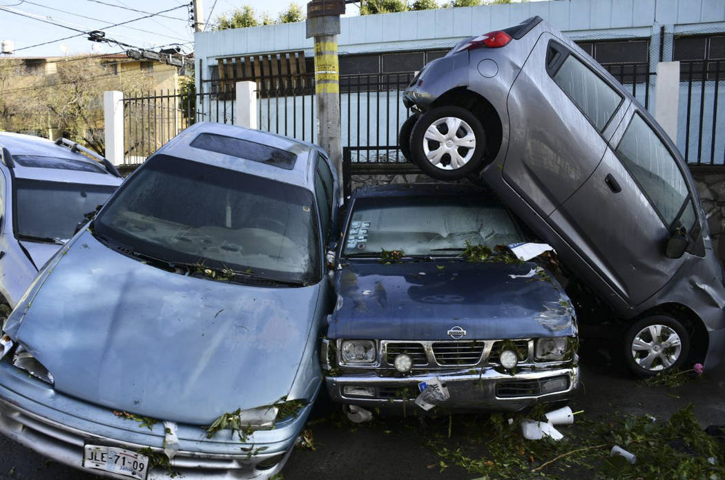 In this photo released by Jalisco State Civil Defense Agency, cars are piled up after a hail st ...