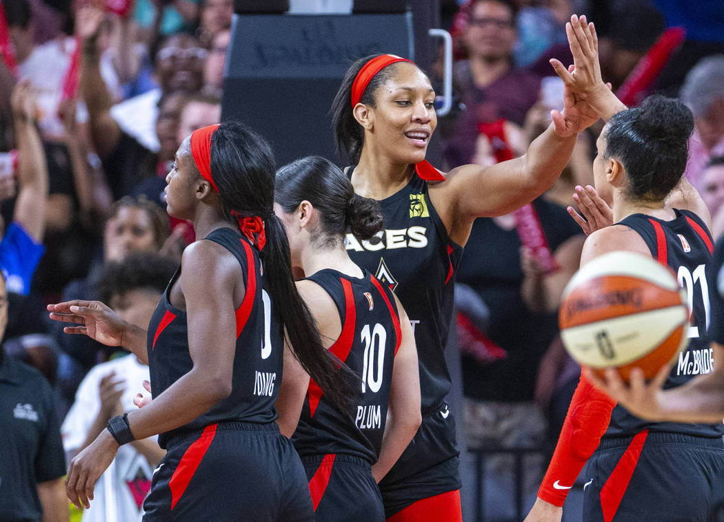 Las Vegas Aces center A'ja Wilson (22) celebrates a win with teammates after their overtime vic ...