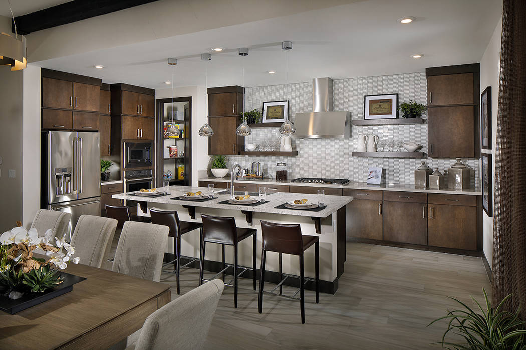 The epicurean kitchen features a central island, walk-in pantry and two-toned counters. (Anthon ...