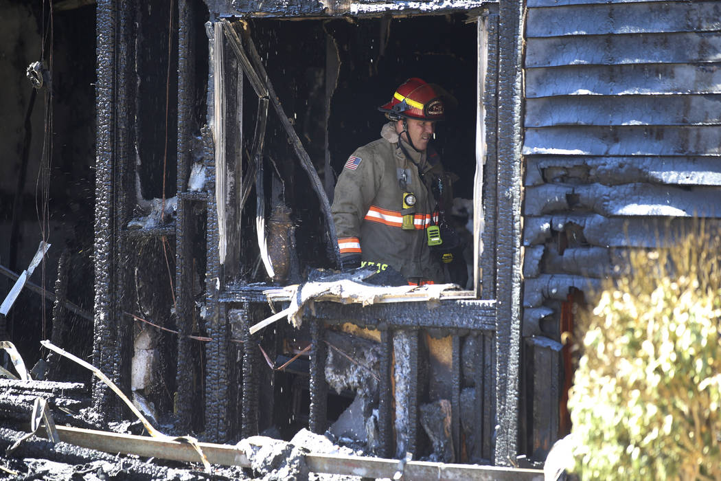 A Clark County fire captain works a three-alarm fire at an apartment complex at 5100 E. Tropica ...