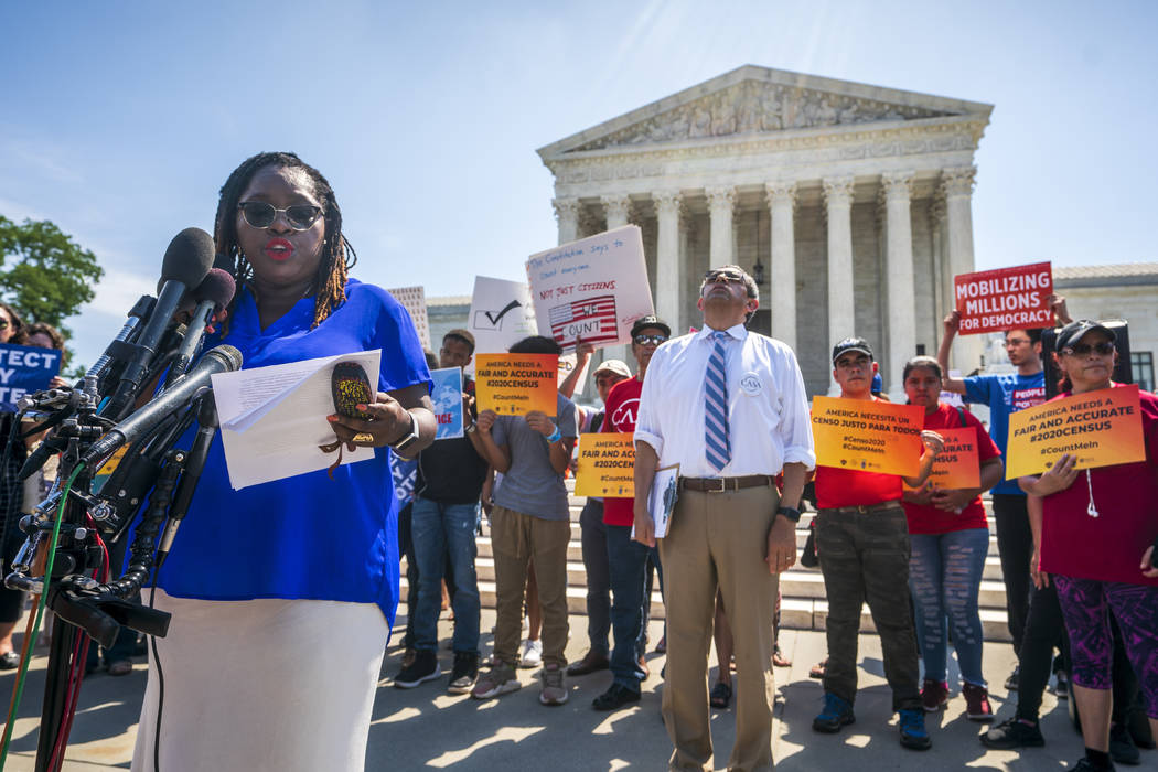 Nana Gyamfi, executive director of the Black Alliance for Just Immigration, left, reads a state ...