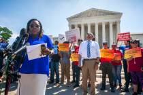 Nana Gyamfi, executive director of the Black Alliance for Just Immigration, left, reads a state ...