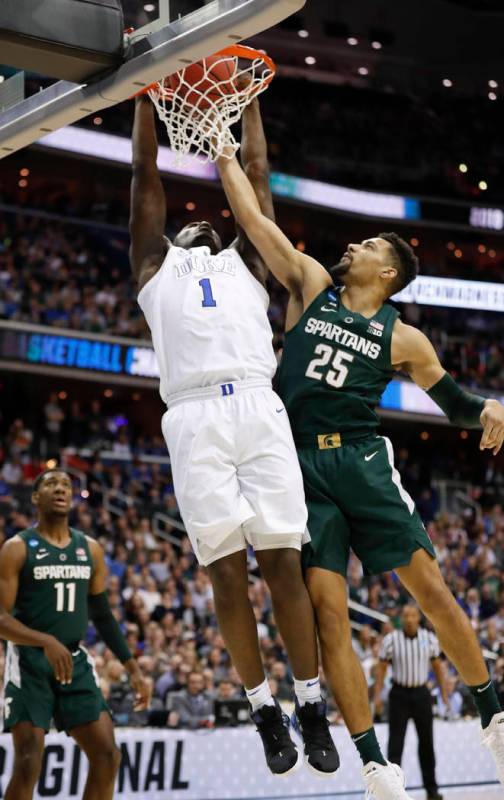 Duke forward Zion Williamson (1) scores against Michigan State forward Kenny Goins (25) during ...