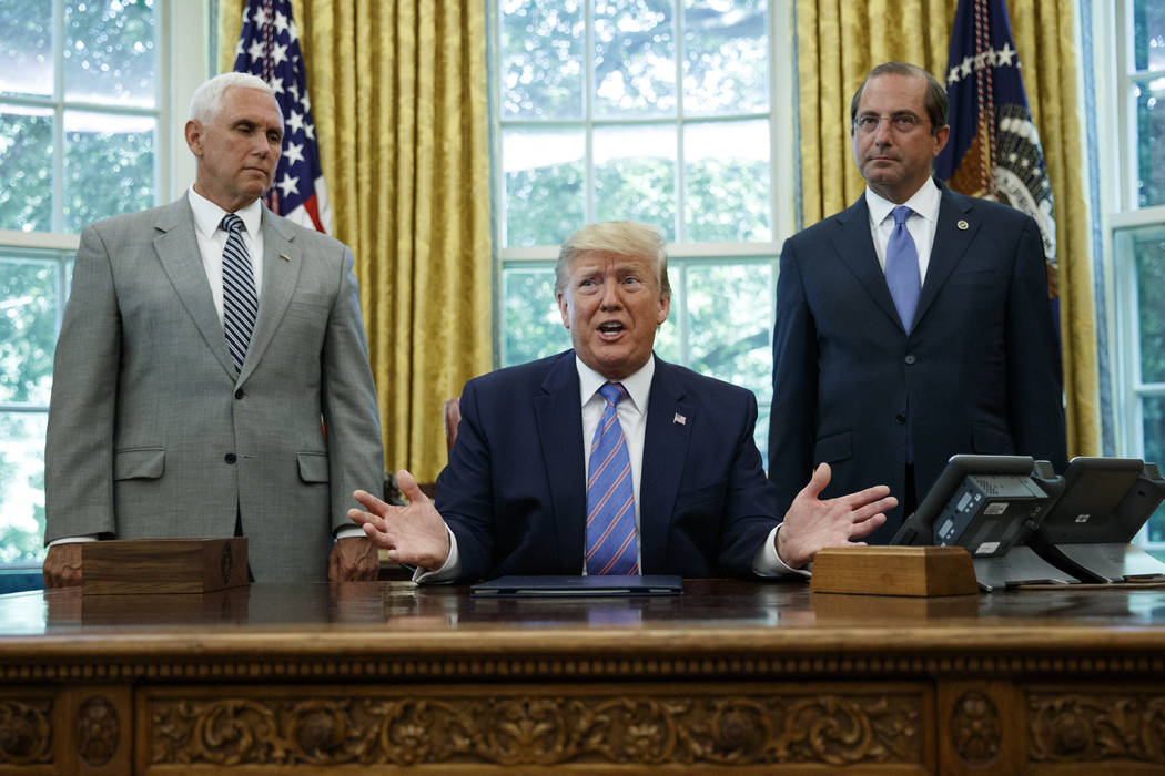 President Donald Trump, joined by Vice President Mike Pence, left, and Secretary of Health and ...