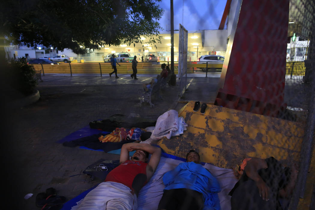 A small group of migrants waiting to seek asylum sleeps at the entrance to the Puerta Mexico in ...